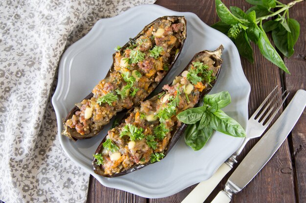 Baked eggplant stuffed with vegetables, meat and cheese