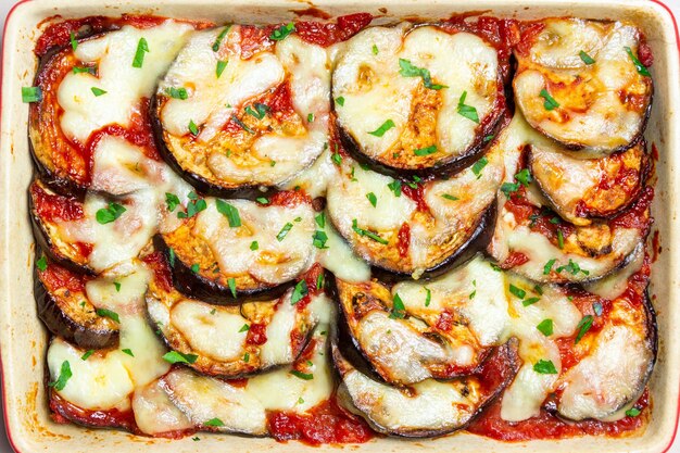 Baked eggplant with cheese mozzarella and tomatoes Healthy eating Italian food Parmigiana di melanzane