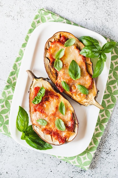 Baked eggplant with tomatoes and mozzarella and basil