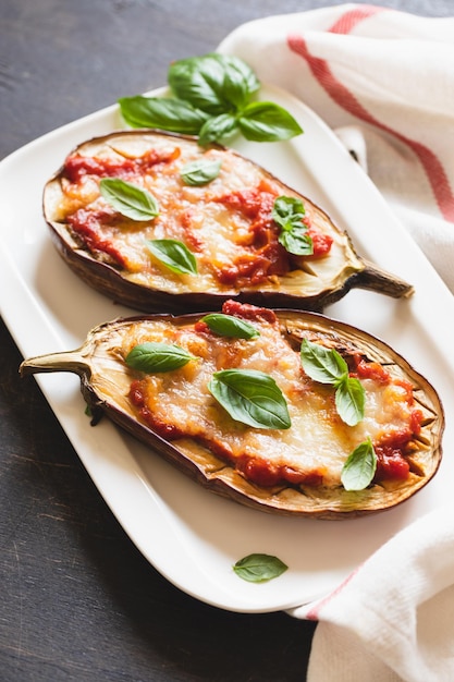 Baked eggplant with tomatoes and mozzarella and basil