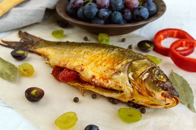 Baked fish carp, stuffed bell peppers and grapes