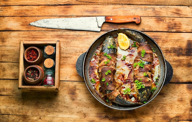 Baked fish wrapped in bacon, fried pelengas