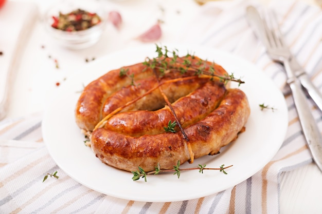 Baked homemade sausage on a white plate. Thanksgiving Day.