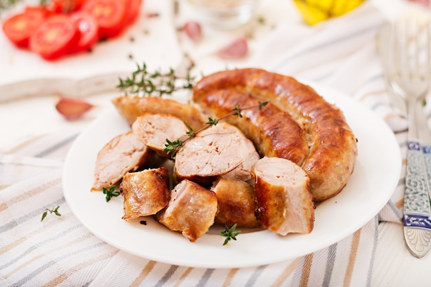 Baked homemade sausage on a white plate. Thanksgiving Day.