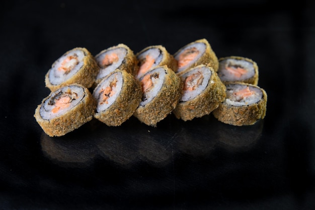 baked japanese rolls on a black background