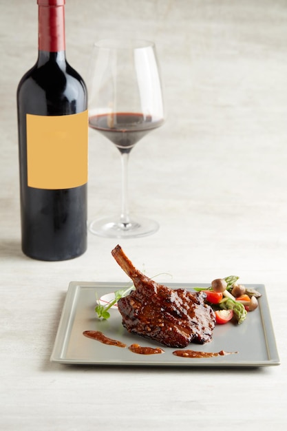 Baked Lamb Rack in Red Wine Reduction served in a dish isolated on grey background