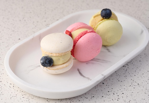 Baked macarons with different flavors on the table dessert