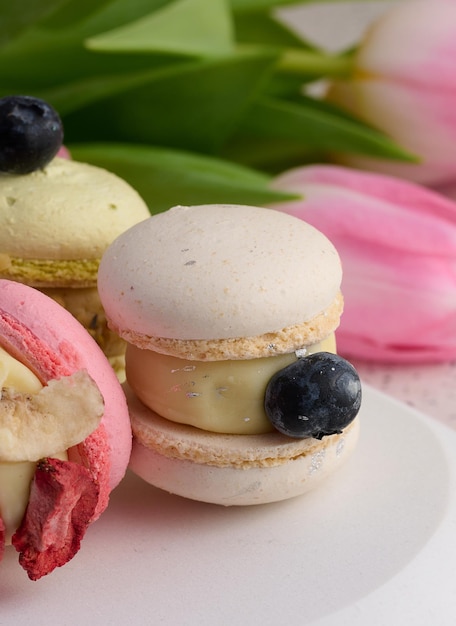 Baked macarons with different flavors on the table dessert