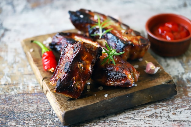 Baked meat ribs. Appetizing hot ribs baked in honey mustard sauce with chili pepper. BBQ ribs.