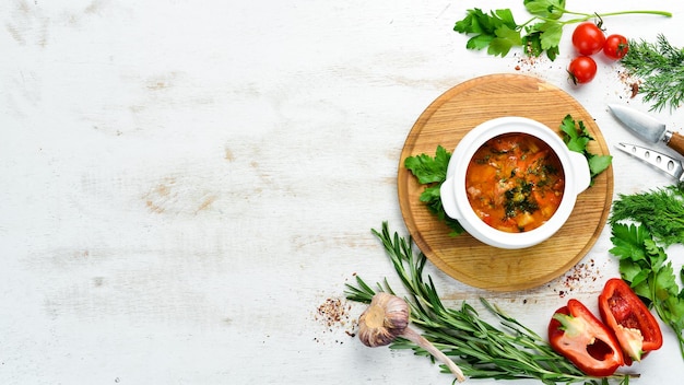 Baked meat with potatoes and vegetables in a bowl Ukrainian traditional cuisine Top view Free space for your text