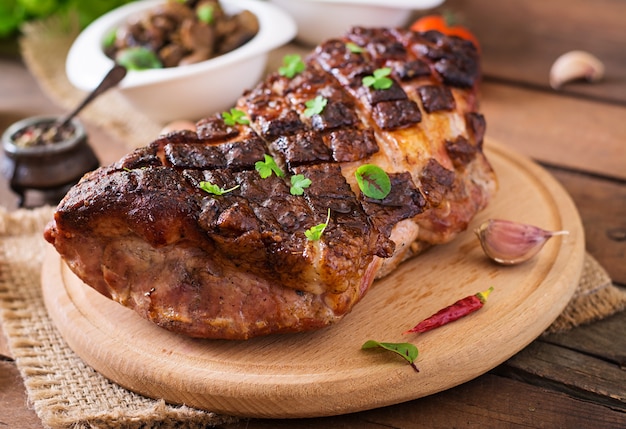 Baked meat with spices and garlic on wooden table