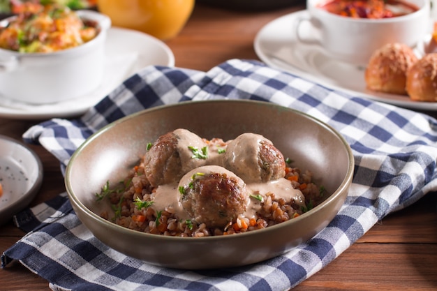 Baked meatballs with creamy mushroom sauce and buckwheat porridge