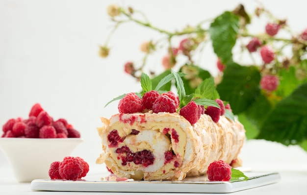 Baked meringue roll with raspberries Whipped egg whites and buttercream delicious dessert