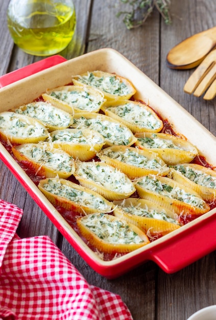 Baked pasta stuffed with cheese and spinach in tomato sauce Vegetarian food Italian food