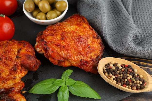 Baked pieces of chicken with olives and spices Fried chicken in a restaurant