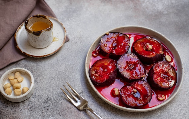 Baked plums with honey, cinnamon and hazelnuts