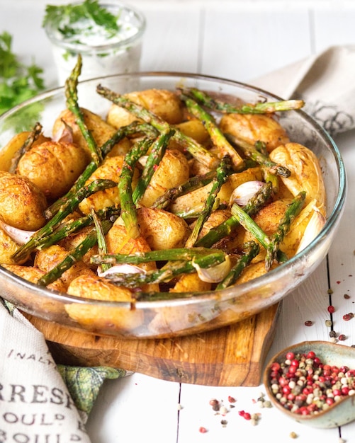 Baked potatoes with asparagus with olive oil A delicious dish is served with cream sauce and herbs