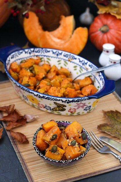 Baked pumpkin slices with garlic and pumpkin seeds