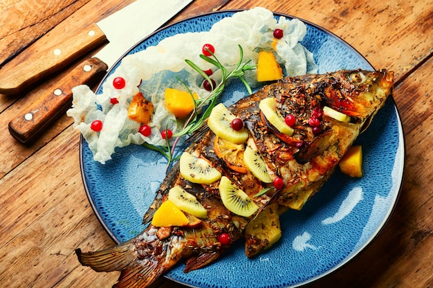 Baked river fish with fruits