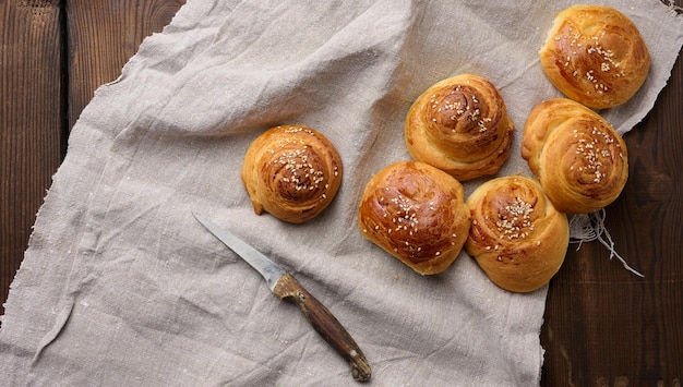 Baked round buns on a wooden table top view