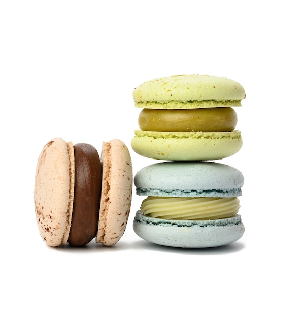 Baked round multicolored macarons on white background, close up