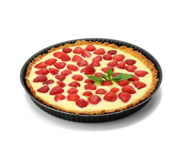 Baked round tart with strawberries and tender milk cream isolated on white surface, top view