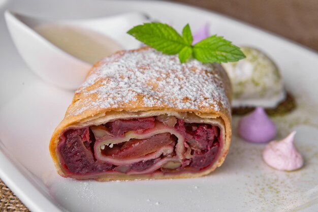 Baked strudel with apple cherries and nuts