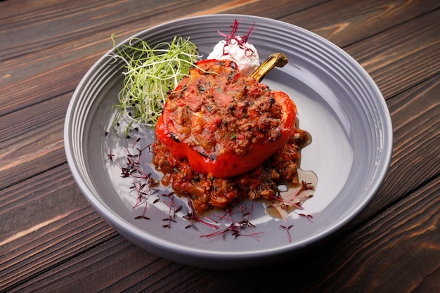 Baked stuffed bell pepper with meat and vegetables on a plate