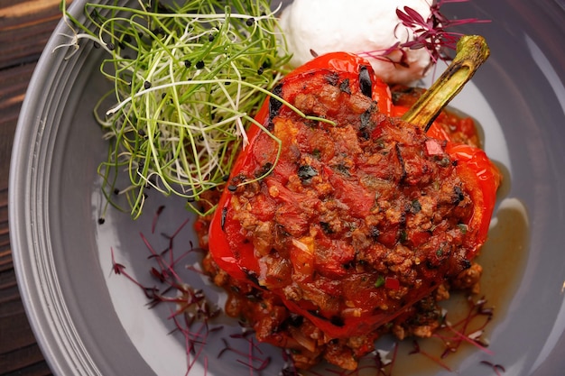 Baked stuffed bell pepper with meat and vegetables on a plate