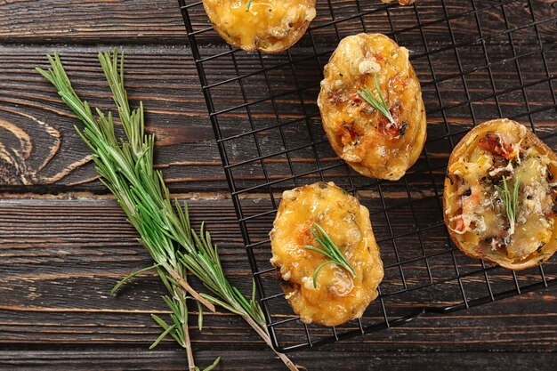 Baked stuffed potatoes on metal grid