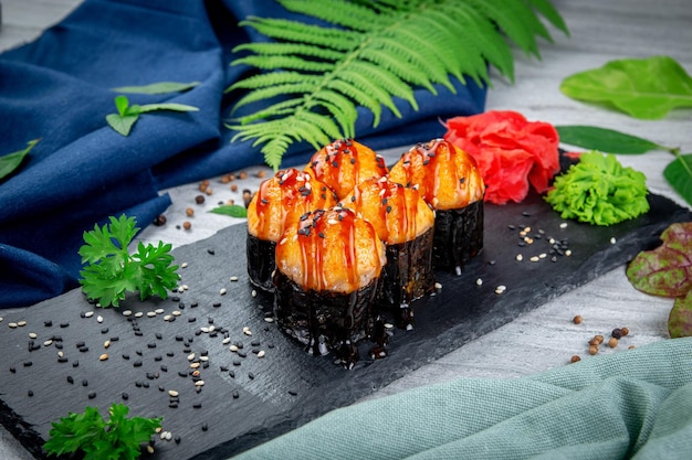 Baked sushi rolls with ayashi cap of crab sauce and unagi sauce Traditional Japanese Cuisine