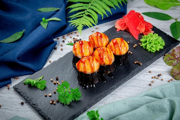 Baked sushi rolls with ayashi cap of crab sauce and unagi sauce Traditional Japanese Cuisine