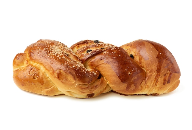 Baked sweet bun made of white wheat flour with raisins isolated on white