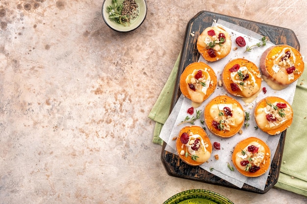 Baked sweet potato with brie cheese cranberry and walnut