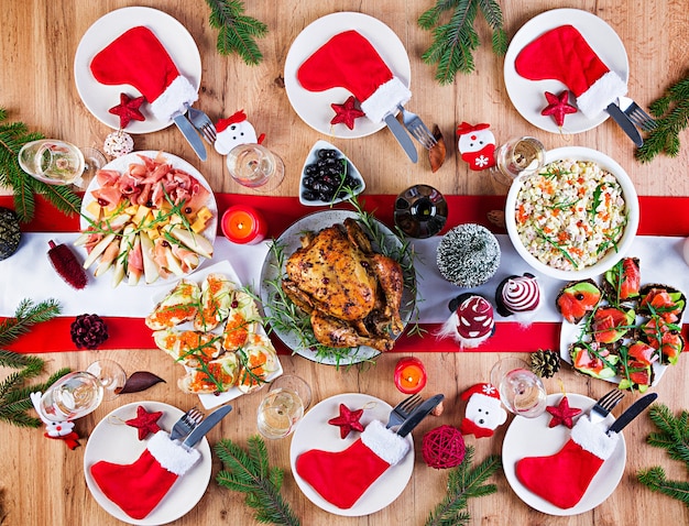 Baked turkey. Christmas dinner. The Christmas table is served with a turkey, decorated with bright tinsel and candles