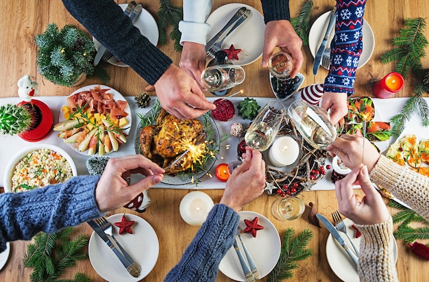 Baked turkey. Christmas dinner. The Christmas table is served with a turkey, decorated with bright tinsel and candles.