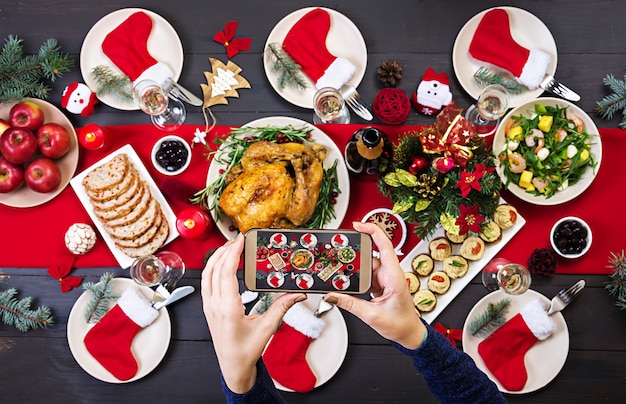 Baked turkey. The Christmas table is served with a turkey, decorated with bright tinsel 