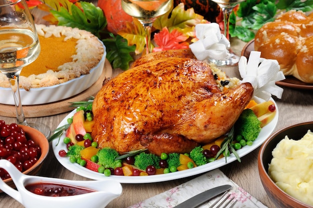 Baked turkey with vegetables pumpkin pie mashed potatoes on the table dinner on Thanksgiving Day