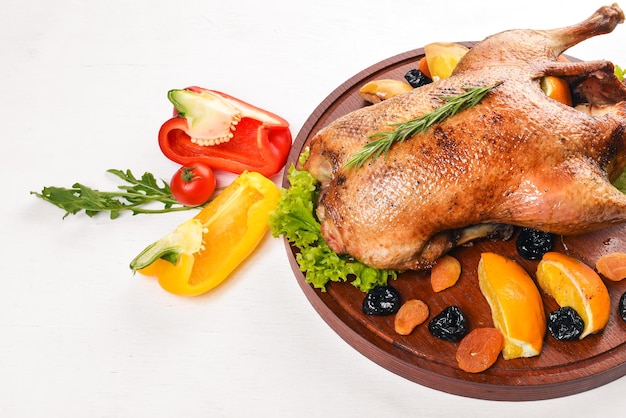 Baked turkey with vegetables and spices Thanksgiving day Goose chicken grill On a wooden background Top view