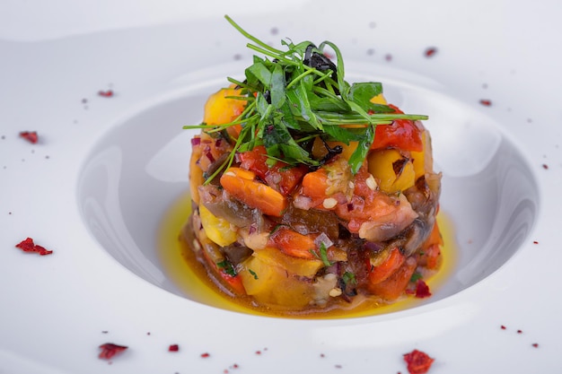 Baked vegetable salad on a plate closeup