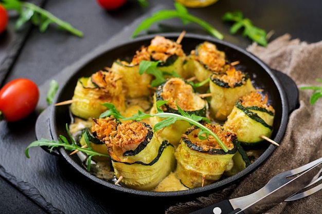 Baked zucchini rolls with cheese, carrot and chicken breast