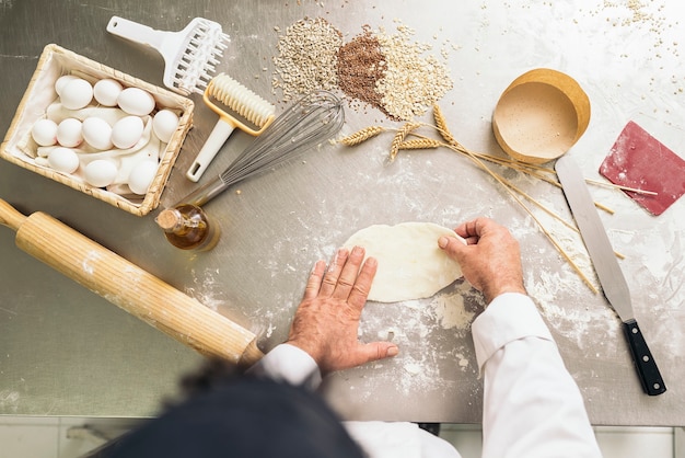 Baker kneading dough in a bakery