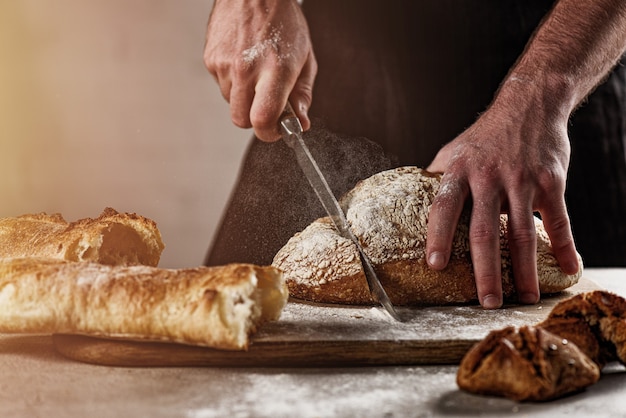 Baker with bread just out of the oven