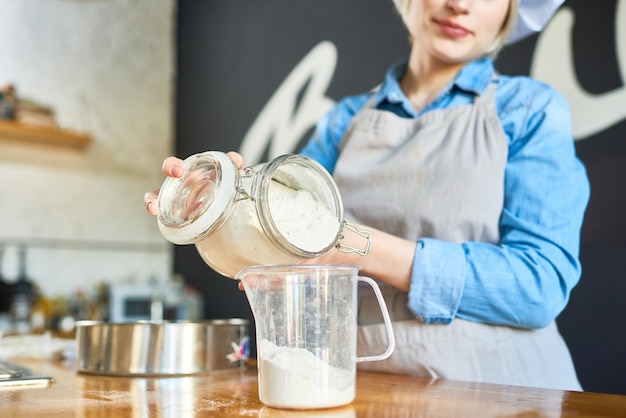 Baker works with flour