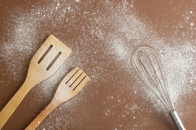 Bakery background whisk Spatula and flour