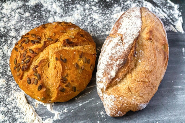 Bakery background with baked bread on flour table