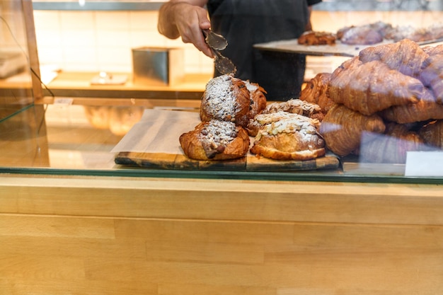 Bakery Busy hands restock a tray of croissants and pastries a heavenly sight at the artisan bakery