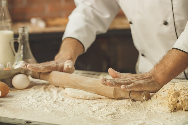 Bakery chef cooking bake in the kitchen professional roll out dough