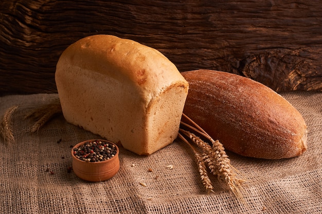 Bakery - gold rustic crusty loaves of bread and buns on black chalkboard background