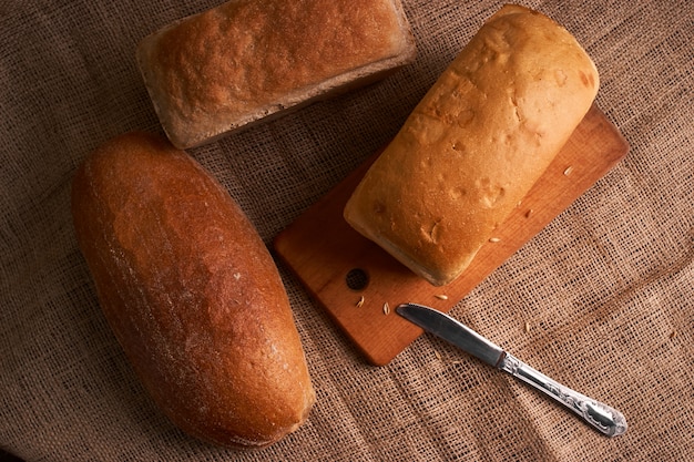 Bakery - gold rustic crusty loaves of bread and buns on black chalkboard background